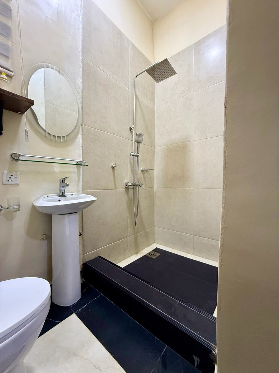 Economy studio suite, Studio suite bathroom with rain shower and pedestal sink