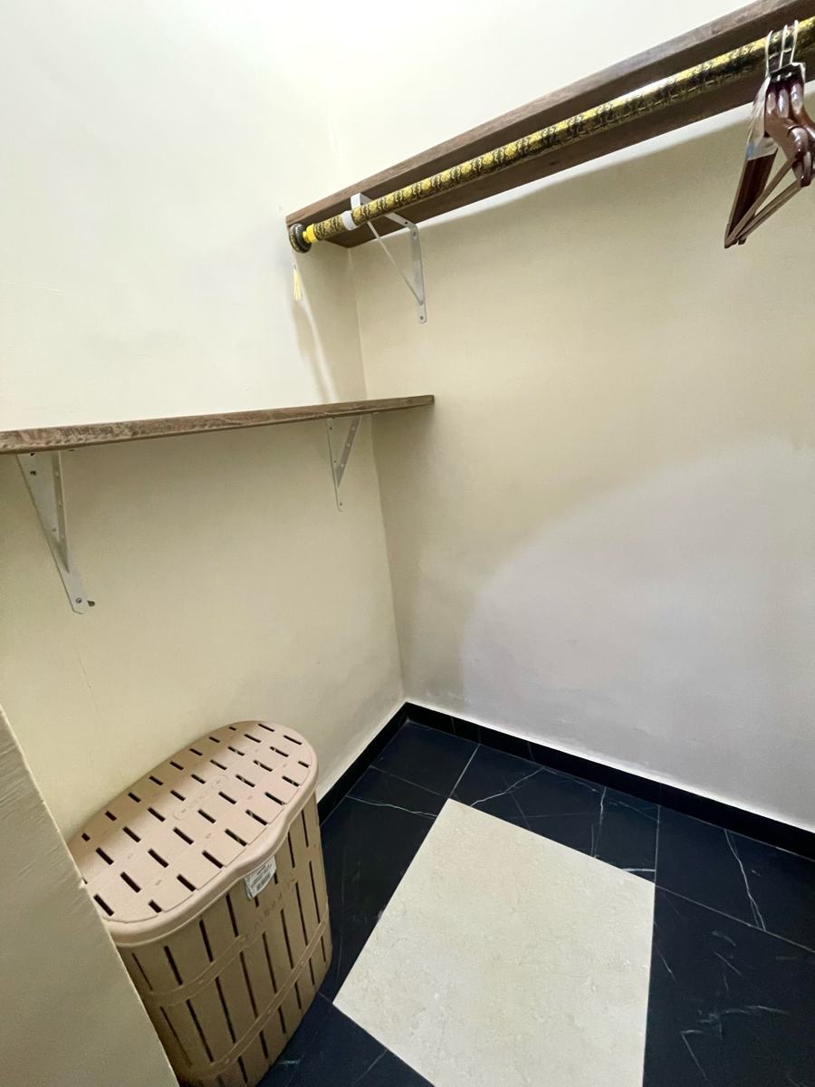 Economy studio suite, Walk-in closet with shelf, hanging rail and laundry basket