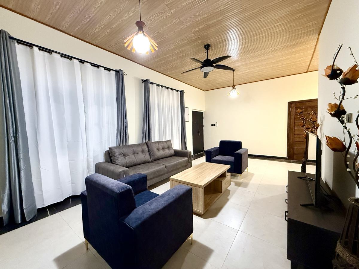 Luxury 2 bedroom, Living room with sofa and navy armchairs