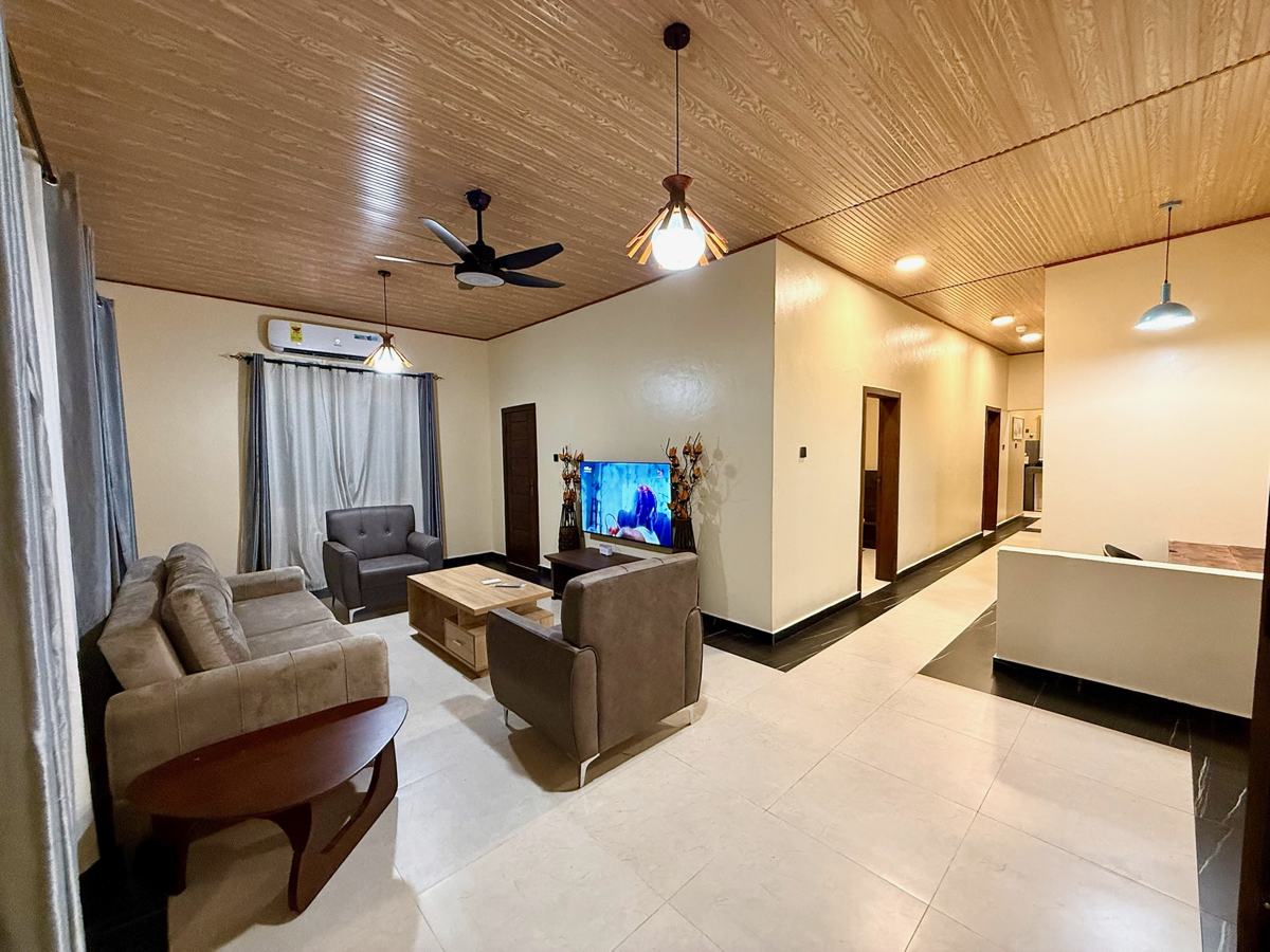 Luxury 1 bedroom, Living room with taupe sofas and TV