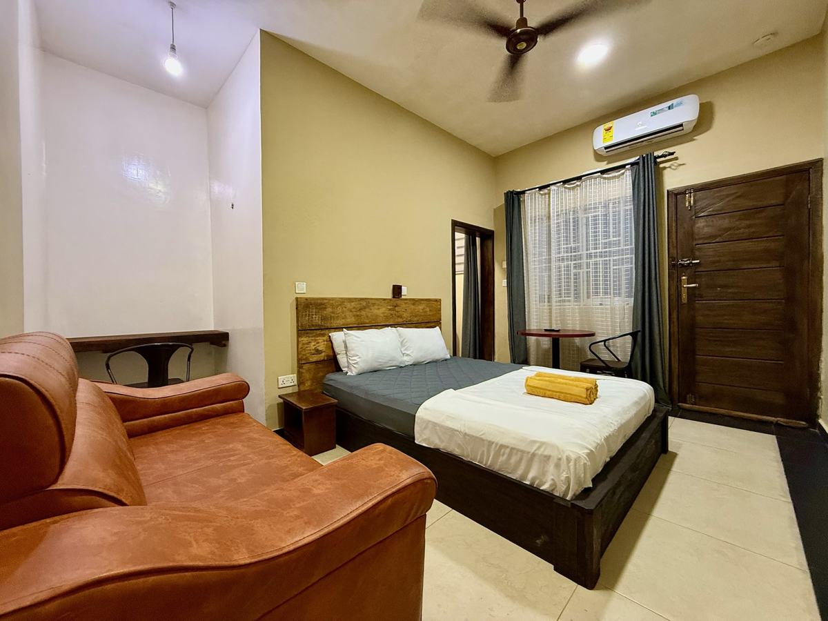 Superior queen studio suite, leather sofa, bed and air conditioner