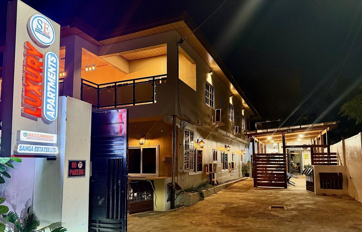 Sanga Estates entrance sign and building at night
