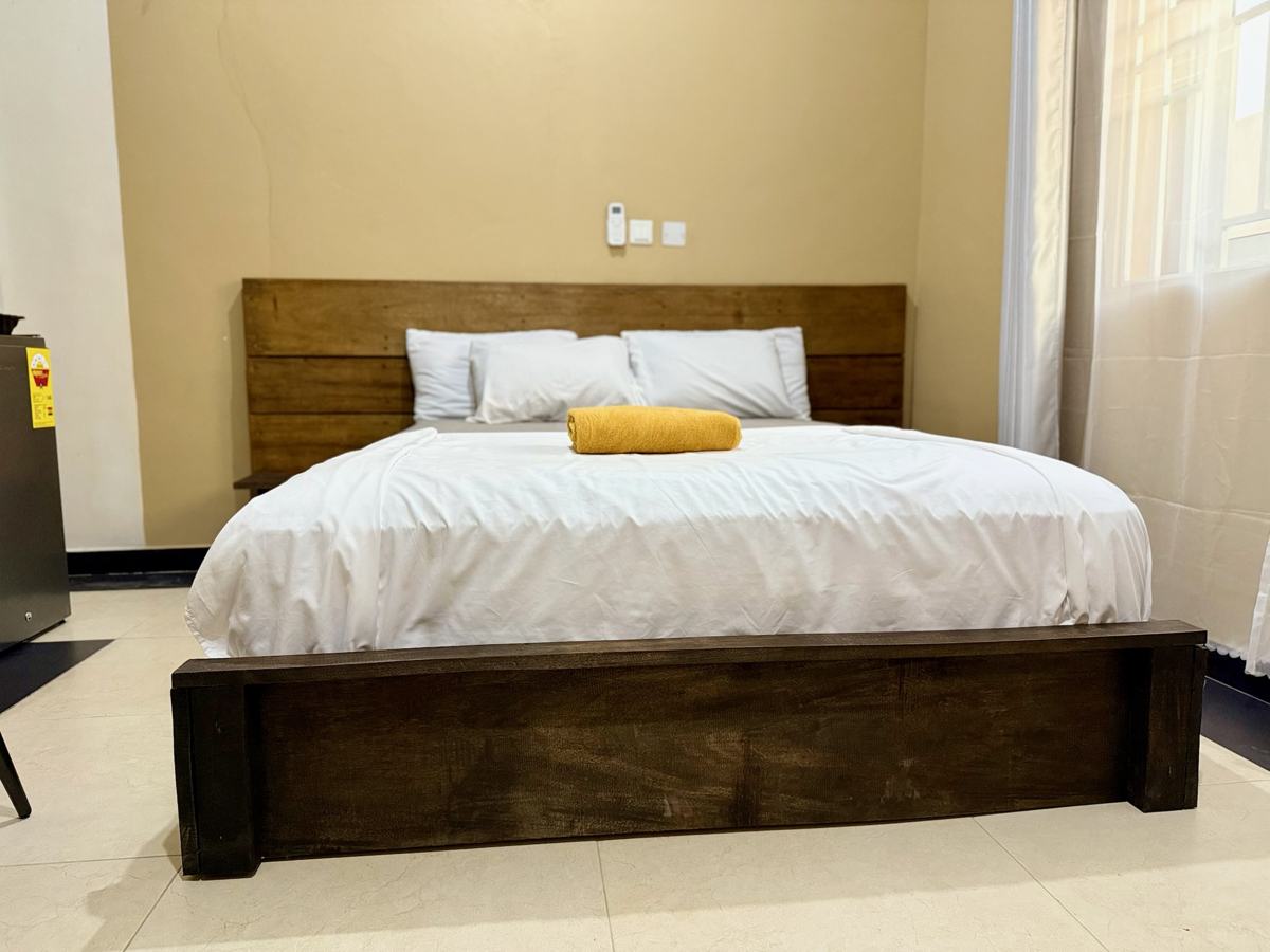 Queen studio suite bed with wooden headboard